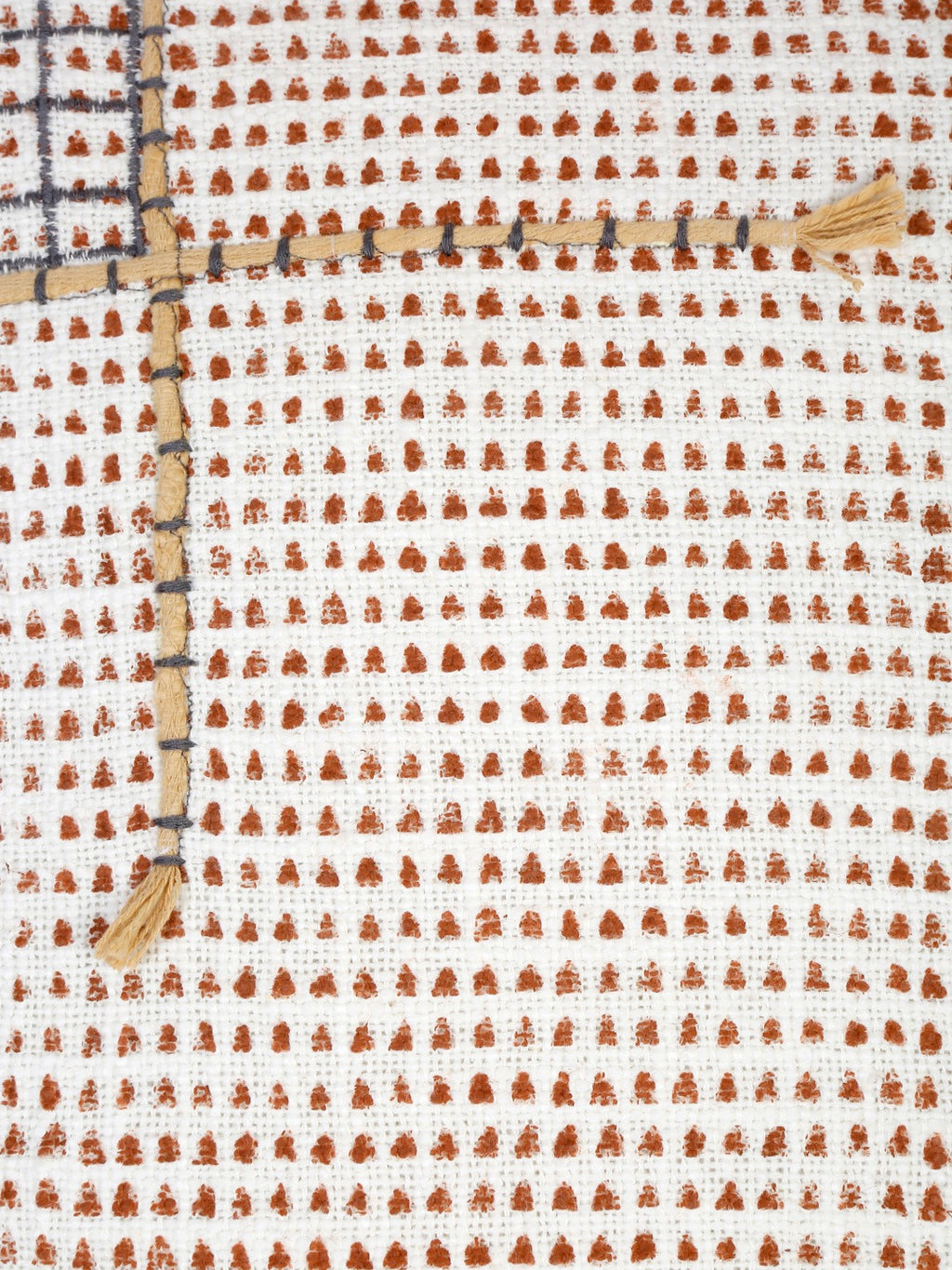 Close-up detail of hand block print and stitched accents on cotton cushion cover