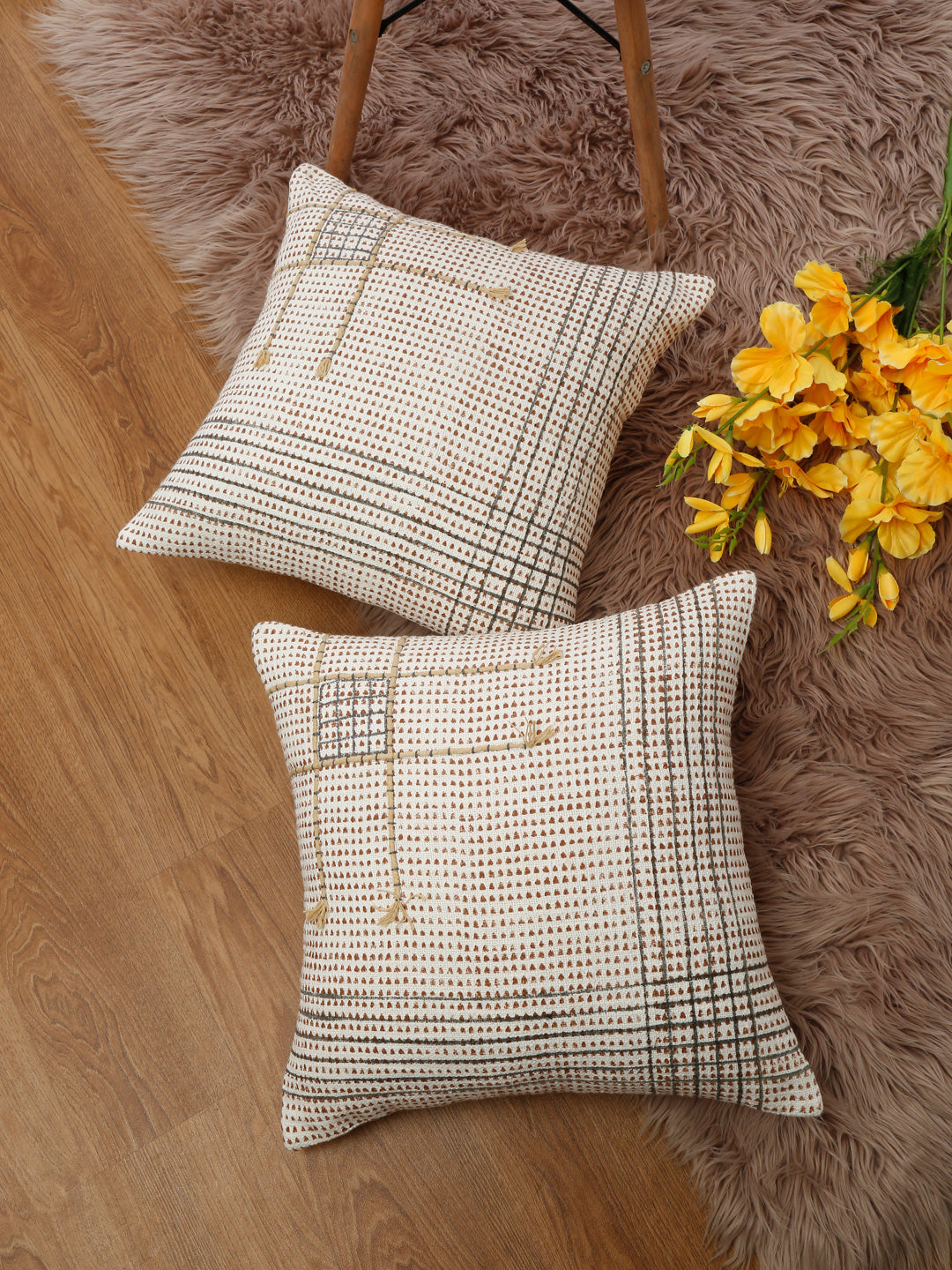 Styled view of hand block printed cotton cushion covers on floor