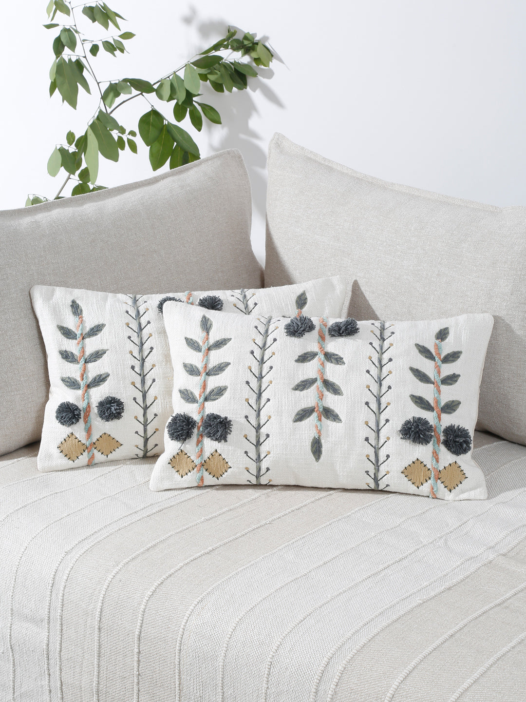 Hand embroidered cotton pillow cover styled on sofa